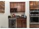Kitchen features a wine rack and beverage cooler with granite countertop at 6701 Sw 94Th Cir, Ocala, FL 34481