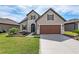 Two-story house with brown garage door and landscaped yard at 6701 Sw 94Th Cir, Ocala, FL 34481