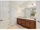 Double vanity bathroom with a large mirror and separate shower at 6701 Sw 94Th Cir, Ocala, FL 34481