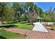 Landscaped backyard with brick walkways and a view of the pool and gazebo at 1321 Sw 42Nd St, Ocala, FL 34471