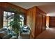 Relaxing sitting area with wood paneling, large windows, and comfortable armchairs at 1321 Sw 42Nd St, Ocala, FL 34471
