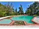 Large swimming pool with brick coping and a separate spa area at 1321 Sw 42Nd St, Ocala, FL 34471