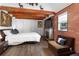 Comfortable bedroom with a fireplace and a brown couch at 14181 Se 211Th Court, Umatilla, FL 32784