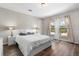 Bright bedroom featuring a king-size bed and large windows with a view at 14181 Se 211Th Court, Umatilla, FL 32784