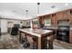 Open-concept kitchen with island seating and a view to living room at 14181 Se 211Th Court, Umatilla, FL 32784