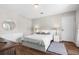 Cozy bedroom with a queen-size bed, wood-look floors, and a window at 14181 Se 211Th Court, Umatilla, FL 32784