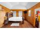 Cozy bedroom featuring a wooden bed frame and unique wall art at 14181 Se 211Th Court, Umatilla, FL 32784