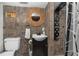 Rustic bathroom with unique tile work and a rainfall shower at 14181 Se 211Th Court, Umatilla, FL 32784
