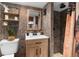 Modern bathroom with stone tile, a walk-in shower, and wood vanity at 14181 Se 211Th Court, Umatilla, FL 32784