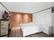 Bright bedroom with brick accent wall, a queen bed, and fireplace at 14181 Se 211Th Court, Umatilla, FL 32784