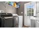 Functional laundry room with washer, dryer, and shelving at 14181 Se 211Th Court, Umatilla, FL 32784