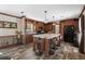 Modern kitchen with an island, dark wood cabinets, and stainless steel appliances at 14181 Se 211Th Court, Umatilla, FL 32784