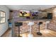 Home bar with stone feature wall, TV, and barstools at 14181 Se 211Th Court, Umatilla, FL 32784