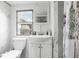 Clean and bright bathroom with white vanity and shower at 14181 Se 211Th Court, Umatilla, FL 32784