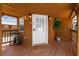 Charming front porch with wooden flooring and a welcoming entrance at 14181 Se 211Th Court, Umatilla, FL 32784