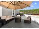 Relaxing deck with seating area, fire pit, and umbrella, overlooking a tranquil landscape at 14181 Se 211Th Court, Umatilla, FL 32784