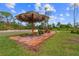 Relaxing patio area with thatched umbrella and seating at 14181 Se 211Th Court, Umatilla, FL 32784