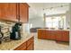 Open kitchen boasts granite counters, wood cabinets, and island at 2515 Nw 53Rd Avenue Rd, Ocala, FL 34482