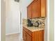 Coffee bar with granite countertop, wood cabinets, and built-in appliances at 2515 Nw 53Rd Avenue Rd, Ocala, FL 34482