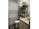 Clean bathroom with shower, toilet, vanity, and storage shelf at 4852 Sw 144Th St, Ocala, FL 34473