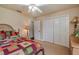 Bedroom with a bed, dresser, and access to closet at 10411 Sw 52Nd Ct, Ocala, FL 34476