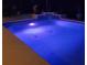 Inviting pool at night with colorful underwater lighting at 10411 Sw 52Nd Ct, Ocala, FL 34476