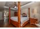 Luxurious main bedroom featuring a post bed and ample closet space at 10411 Sw 52Nd Ct, Ocala, FL 34476
