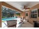 Relaxing pool area with covered patio, comfortable seating, and pool access at 10411 Sw 52Nd Ct, Ocala, FL 34476