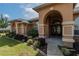 House exterior with arched entryway and landscaping at 10411 Sw 52Nd Ct, Ocala, FL 34476