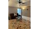 Spacious Gathering room with a large TV, comfortable seating, and a ceiling fan at 10411 Sw 52Nd Ct, Ocala, FL 34476