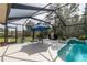 Screened pool enclosure with patio furniture, pool, and lush landscaping at 10411 Sw 52Nd Ct, Ocala, FL 34476