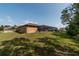 Backyard view of single story home with screened pool and shed at 10411 Sw 52Nd Ct, Ocala, FL 34476