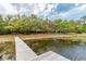 Two cottages and dock on a peaceful lake, surrounded by lush greenery at 22645 Ne 105Th Avenue Rd, Fort Mc Coy, FL 32134
