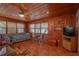Living room with wood walls, built-in shelves and a TV at 22645 Ne 105Th Avenue Rd, Fort Mc Coy, FL 32134