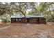 Rustic brown cabin with metal roof, brick base, and screen door at 22645 Ne 105Th Avenue Rd, Fort Mc Coy, FL 32134
