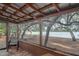 Relaxing screened porch with lake views and wooden chairs at 22645 Ne 105Th Avenue Rd, Fort Mc Coy, FL 32134