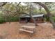 Rustic cottage with screened porch and picnic table, nestled among mature oak trees at 22645 Ne 105Th Avenue Rd, Fort Mc Coy, FL 32134