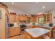 Bright kitchen with wood cabinets, stainless steel appliances, and an island at 22649 Ne 105Th Avenue Rd, Fort Mc Coy, FL 32134