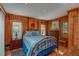 Bedroom with wood walls and a metal bed frame at 22649 Ne 105Th Avenue Rd, Fort Mc Coy, FL 32134