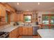 Kitchen with wood cabinets, granite countertops, and stainless steel appliances at 22649 Ne 105Th Avenue Rd, Fort Mc Coy, FL 32134