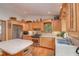 Kitchen with wood cabinets, island, and stainless steel appliances at 22649 Ne 105Th Avenue Rd, Fort Mc Coy, FL 32134