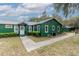 Picturesque green house with walkway and beautiful landscaping at 22649 Ne 105Th Avenue Rd, Fort Mc Coy, FL 32134