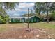 Green house with a spacious yard and outdoor shower at 22649 Ne 105Th Avenue Rd, Fort Mc Coy, FL 32134