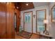Entryway with wood walls, white door, and wood floors at 22649 Ne 105Th Avenue Rd, Fort Mc Coy, FL 32134