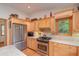 Kitchen with wood cabinets, stainless steel appliances, and granite countertops at 22649 Ne 105Th Avenue Rd, Fort Mc Coy, FL 32134