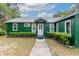 Green house exterior with white door and walkway at 22649 Ne 105Th Avenue Rd, Fort Mc Coy, FL 32134