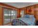 Bedroom with lake view, wood walls, and a metal bed frame at 22649 Ne 105Th Avenue Rd, Fort Mc Coy, FL 32134