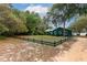 Green house with a fenced yard and lake view at 22649 Ne 105Th Avenue Rd, Fort Mc Coy, FL 32134