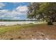 Serene waterfront view with a dock and lily pads at 22649 Ne 105Th Avenue Rd, Fort Mc Coy, FL 32134