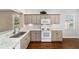 Well-equipped kitchen, featuring granite countertops and white appliances at 9423 Se 130Th Street Rd, Summerfield, FL 34491